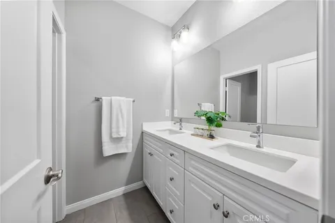 a bathroom with a double vanity sink and mirror
