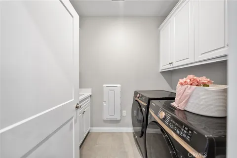 a hallway with a stove top oven and cabinets