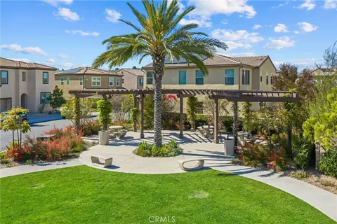 a view of a house with swimming pool and sitting area