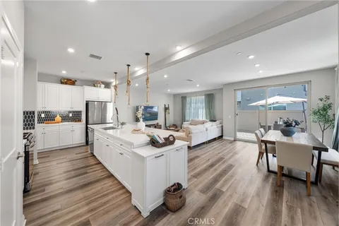 a large white kitchen with a large window