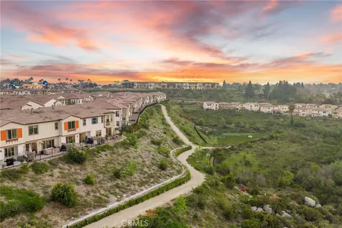 an aerial view of residential houses with outdoor space and river