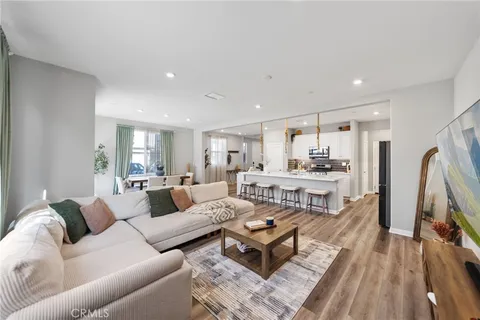 a living room with furniture wooden floor and a flat screen tv