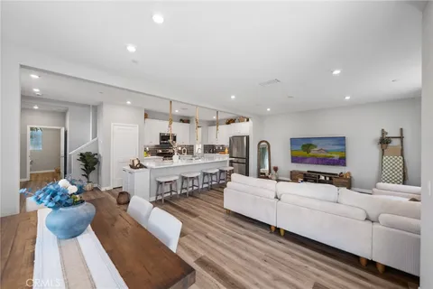 a living room with furniture kitchen and a table