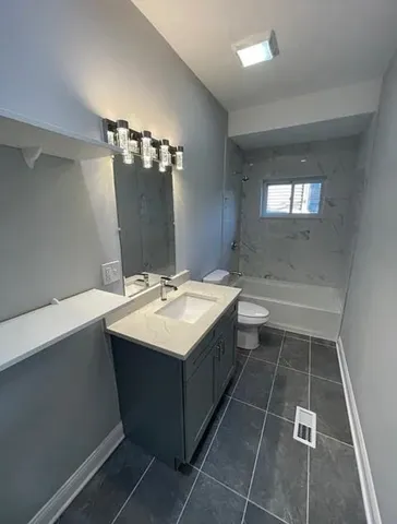 a bathroom with a sink toilet and mirror