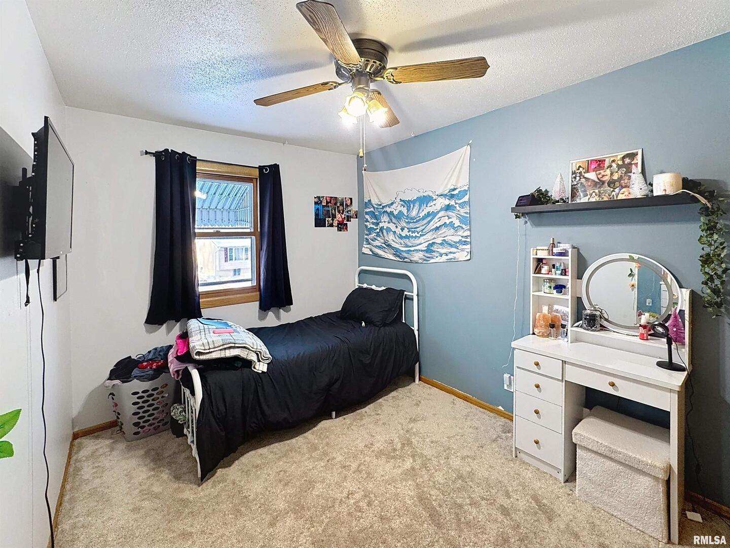 8119 10th Street West Rock Island, IL 61201 - Photo 11 of 25 a bedroom with a bed and a chandelier