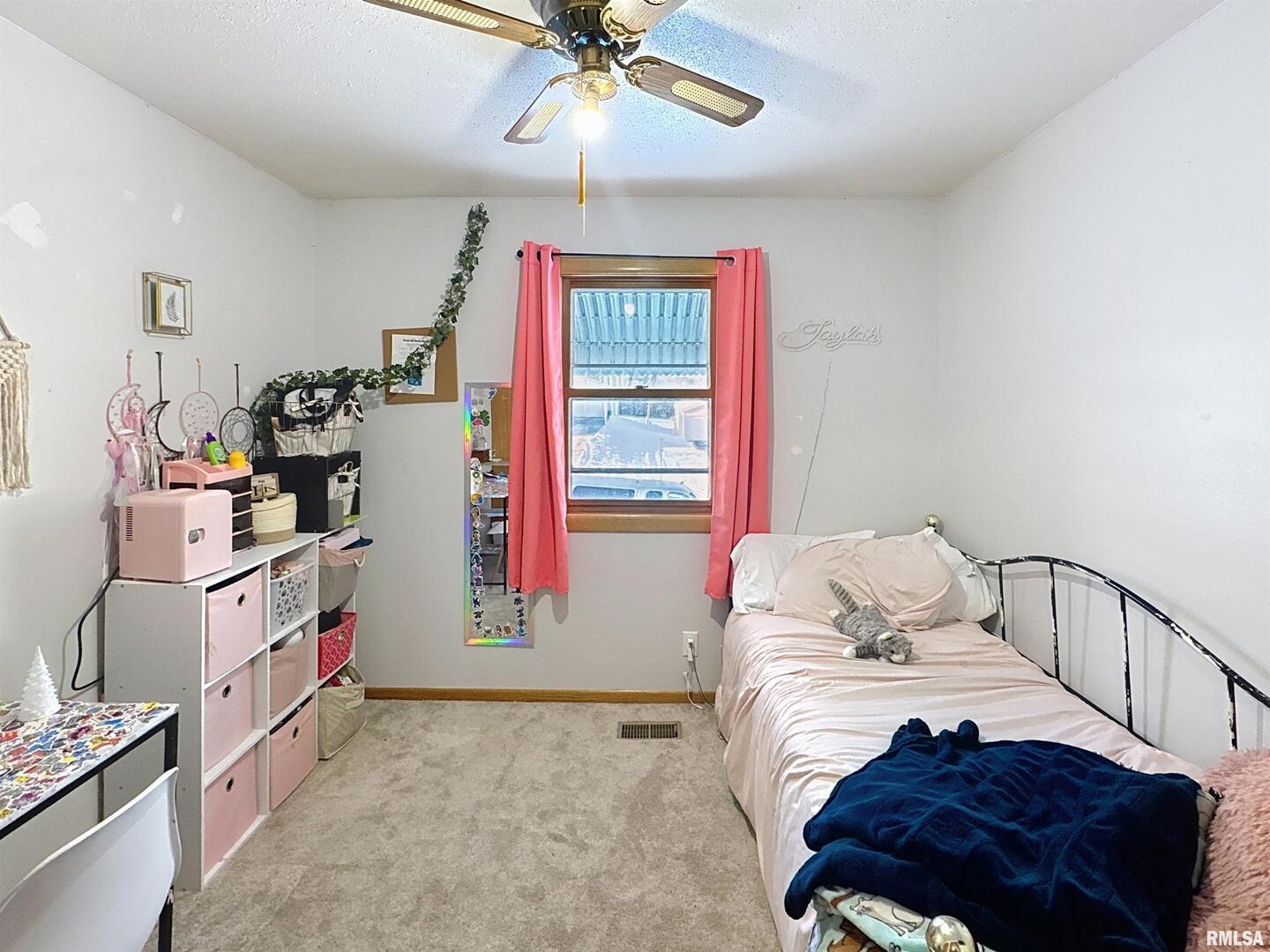 8119 10th Street West Rock Island, IL 61201 - Photo 13 of 25 a bedroom with bed and a window