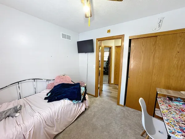 a bedroom with a bed and a chair