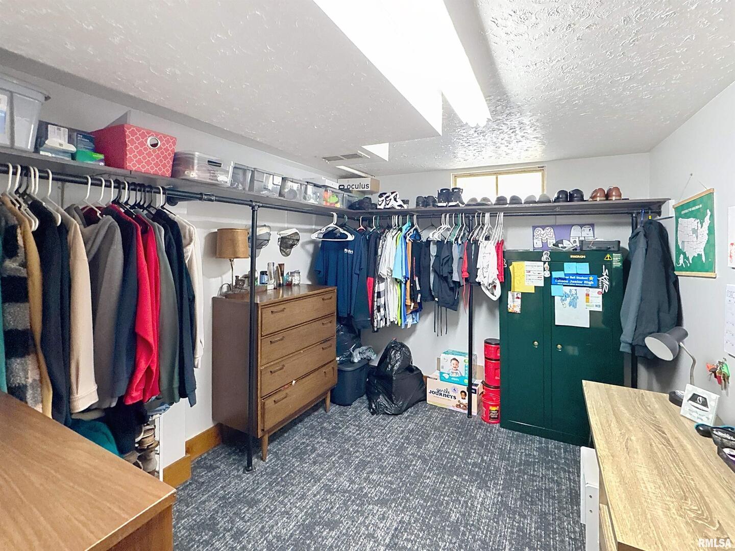 8119 10th Street West Rock Island, IL 61201 - Photo 19 of 25 a view of walk in closet with clothes and shoes