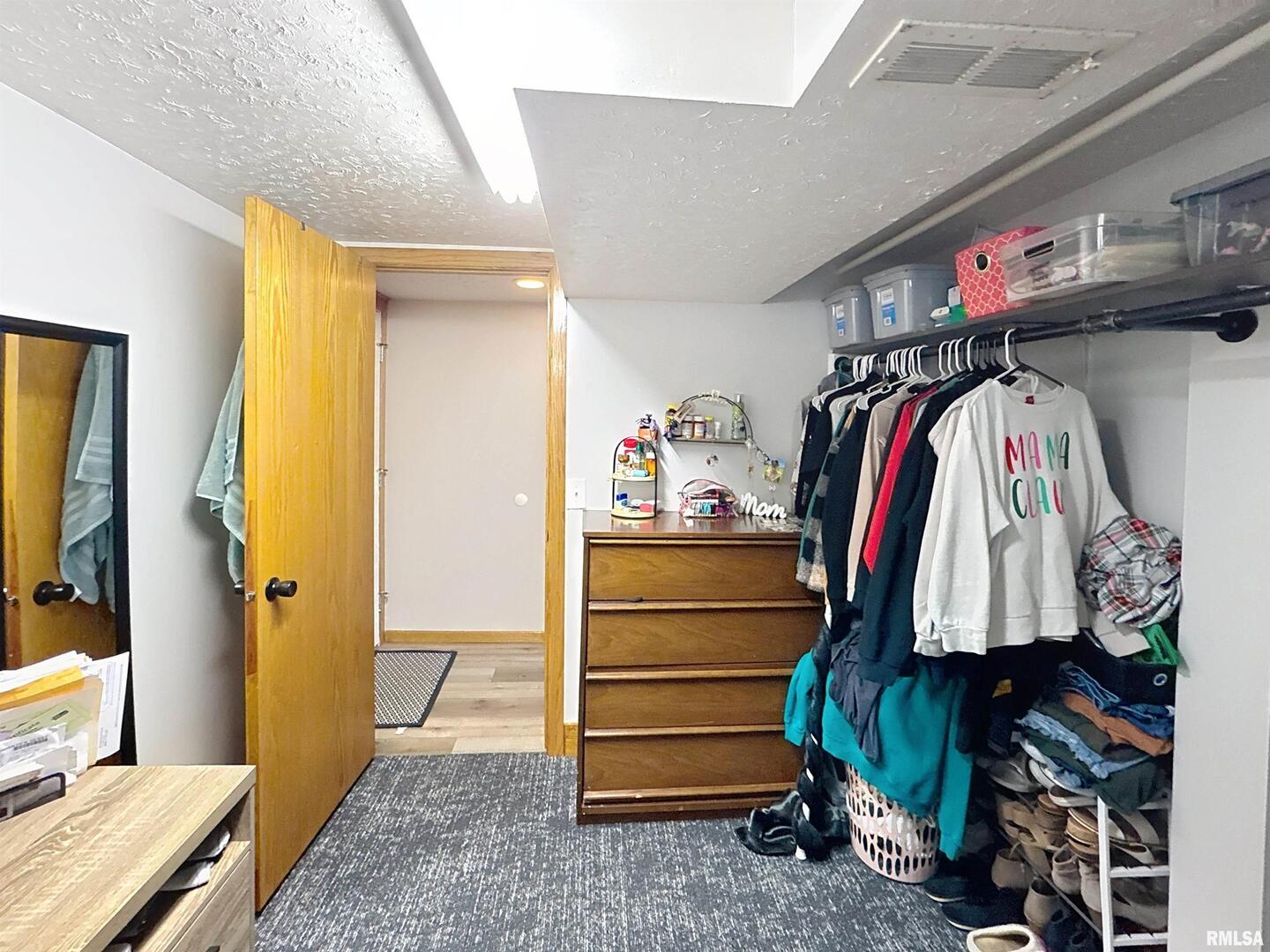 8119 10th Street West Rock Island, IL 61201 - Photo 20 of 25 a view of walk in closet with clothes and shoes