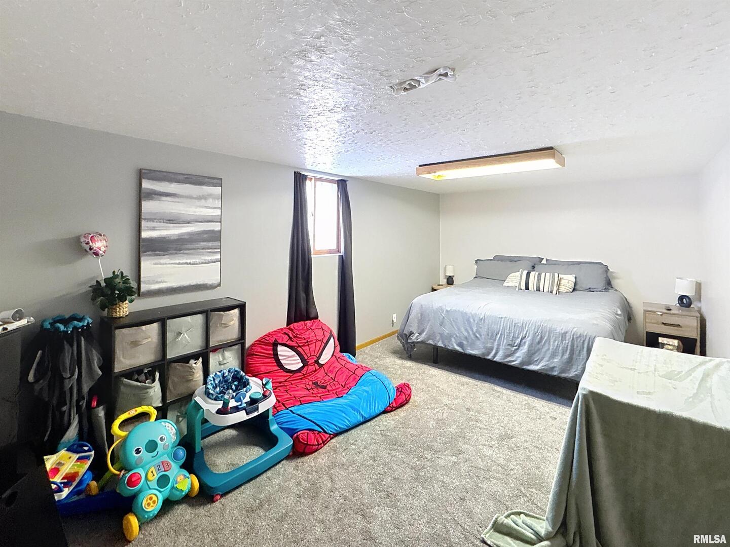 8119 10th Street West Rock Island, IL 61201 - Photo 21 of 25 a bedroom with bed and a window