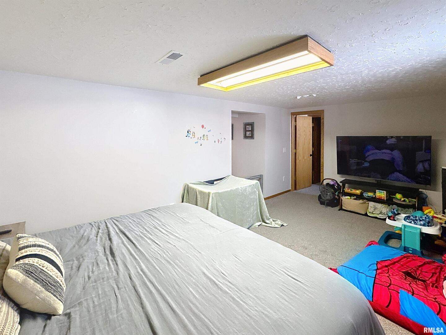 8119 10th Street West Rock Island, IL 61201 - Photo 22 of 25 a bedroom with a bed and a flat screen tv