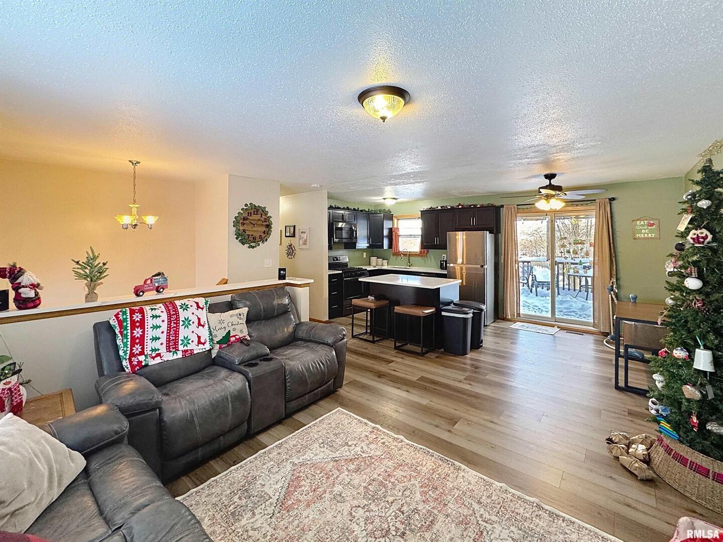 8119 10th Street West Rock Island, IL 61201 - Photo 5 of 25 a living room with furniture and a wooden floor