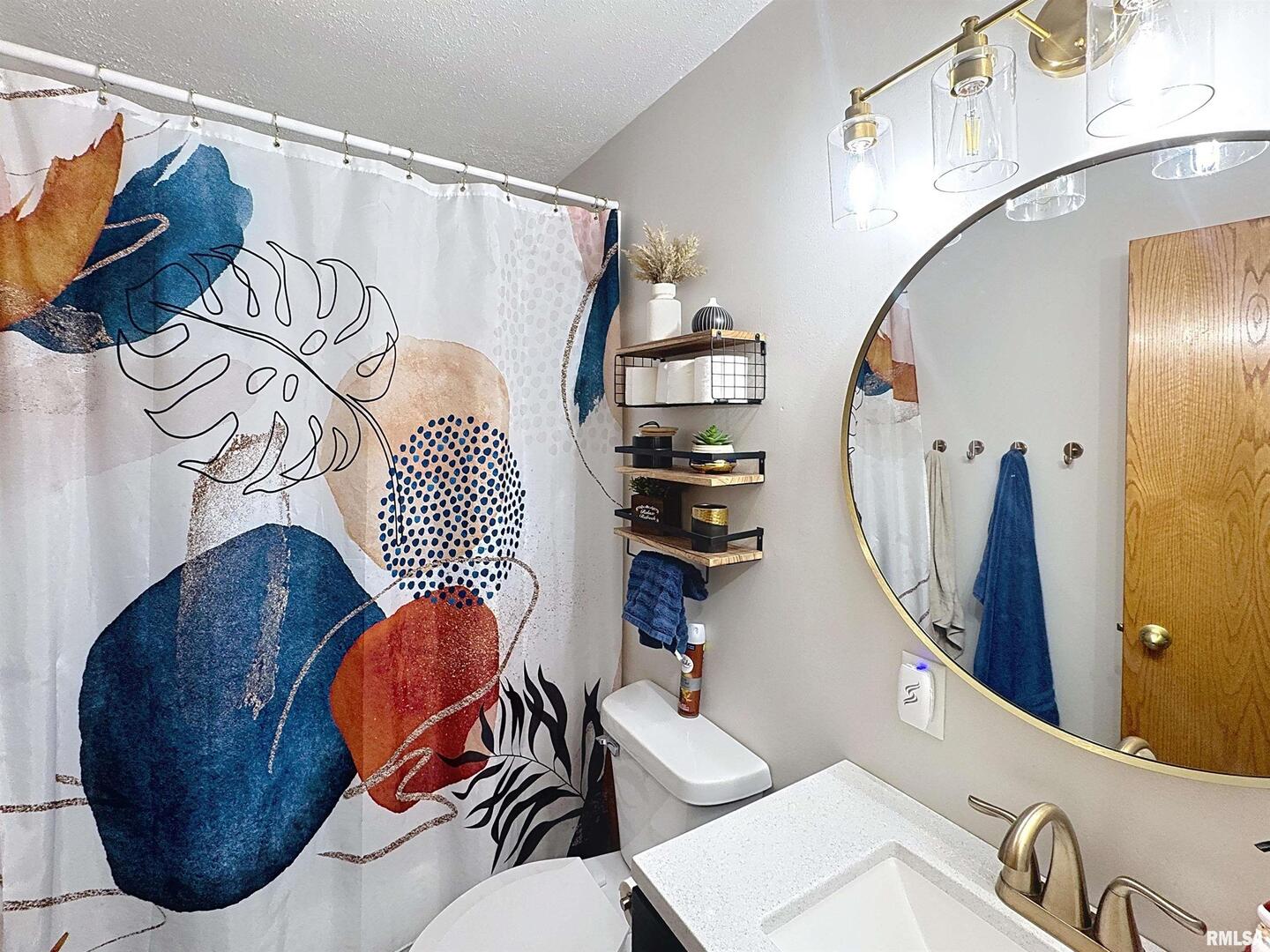 8119 10th Street West Rock Island, IL 61201 - Photo 8 of 25 a bathroom with a toilet sink and mirror