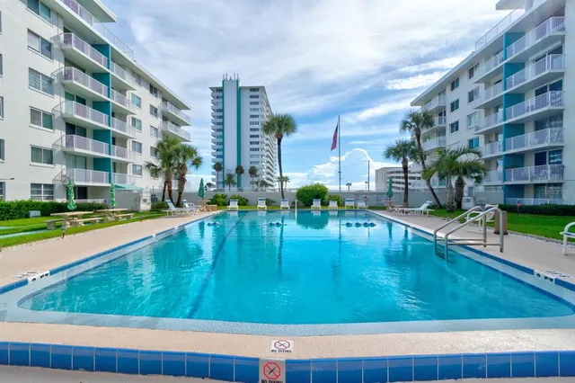 a swimming pool view with a outdoor seating