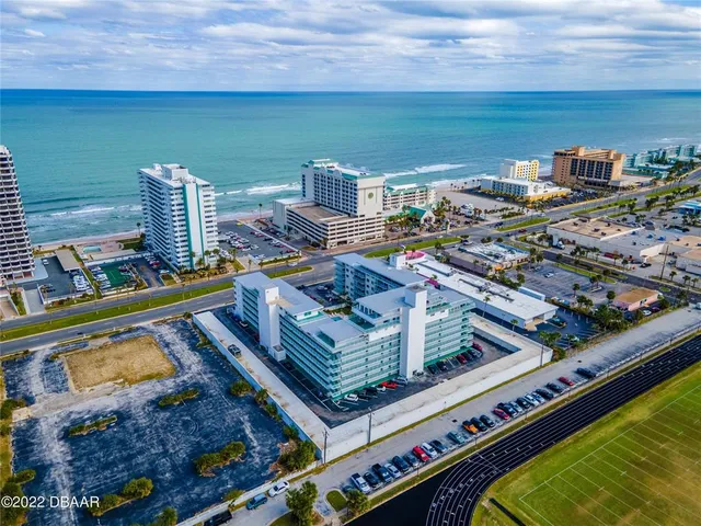 a view of swimming pool with outdoor seating and city view