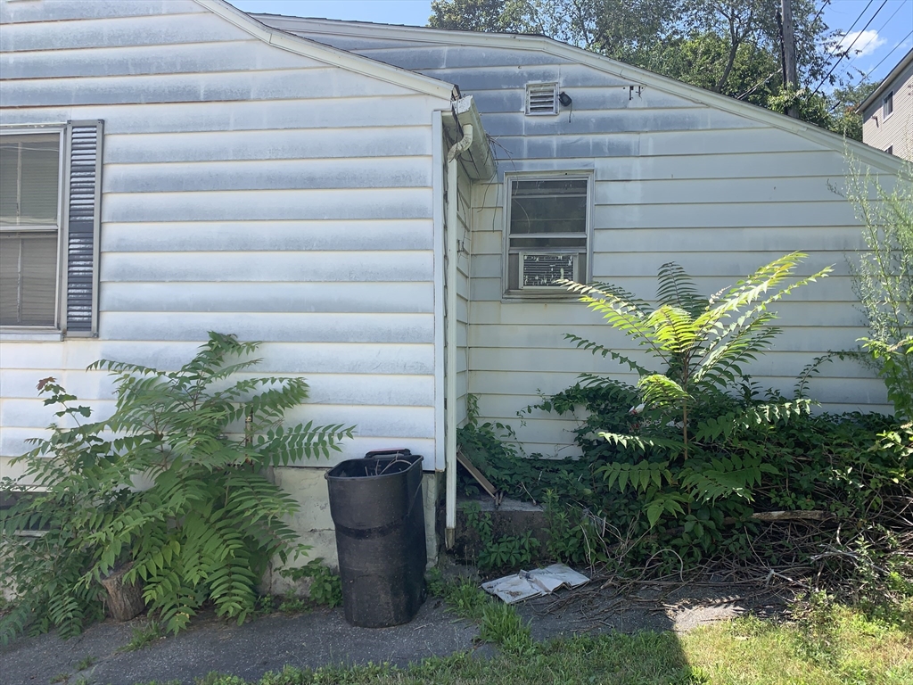a flower garden in front of a house