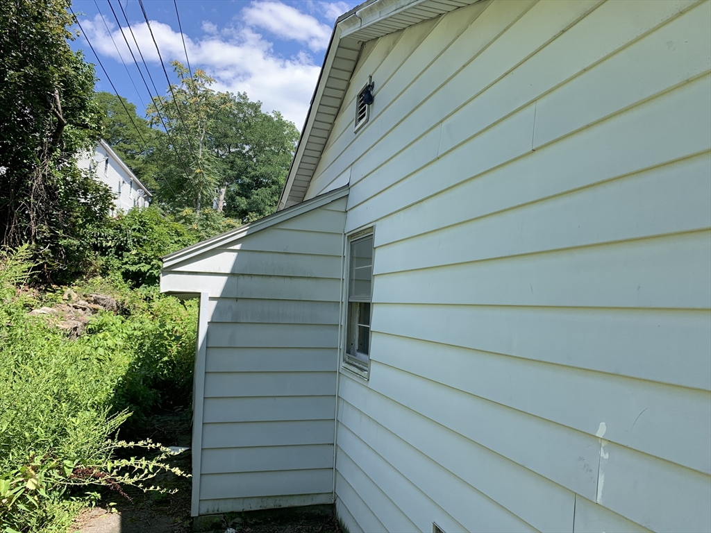 25 Johnson Street Worcester, MA 01604 - Photo 5 of 8 a view of wooden house and a yard