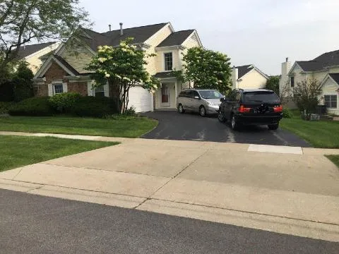 a car parked in front of house with a yard