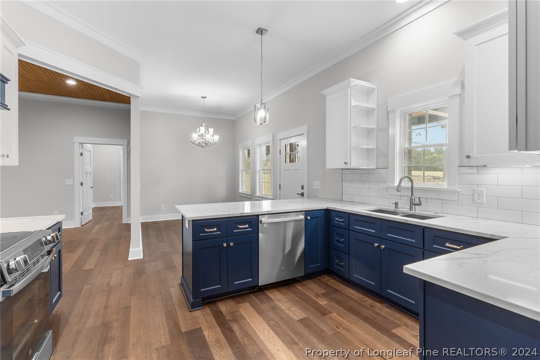 452 Brown Road Carthage, NC 28327 - Photo 16 of 50 a large kitchen with kitchen island granite countertop a sink dishwasher stove and cabinets