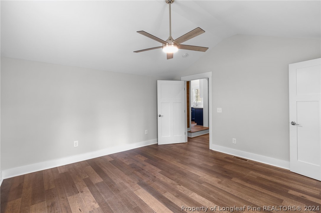 452 Brown Road Carthage, NC 28327 - Photo 22 of 50 a view of an empty room with wooden floor and a ceiling fan