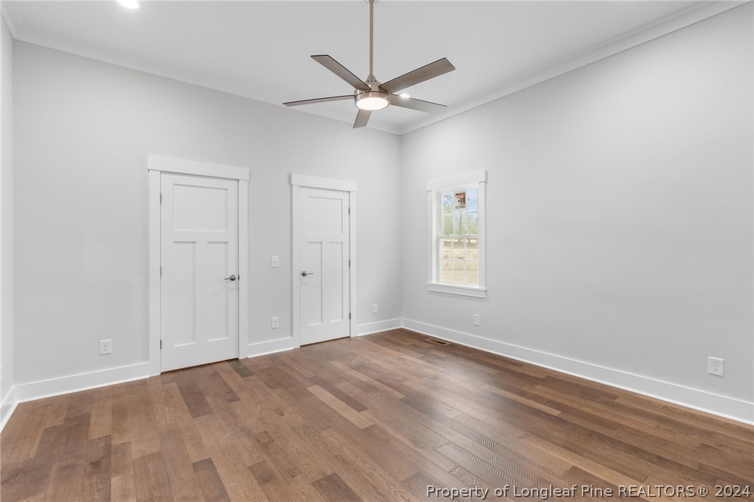 452 Brown Road Carthage, NC 28327 - Photo 34 of 50 an empty room with wooden floor ceiling fan and windows