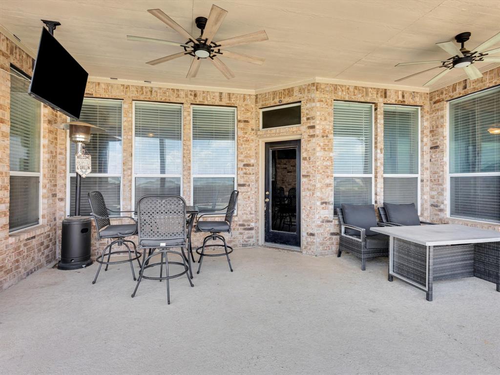 205 King George Road Ponder, TX 76259 - Photo 24 of 37 Covered patio featuring brick exterior walls and multiple windows with blinds