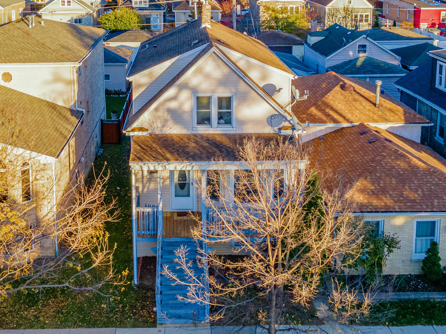 a front view of a house with a tree