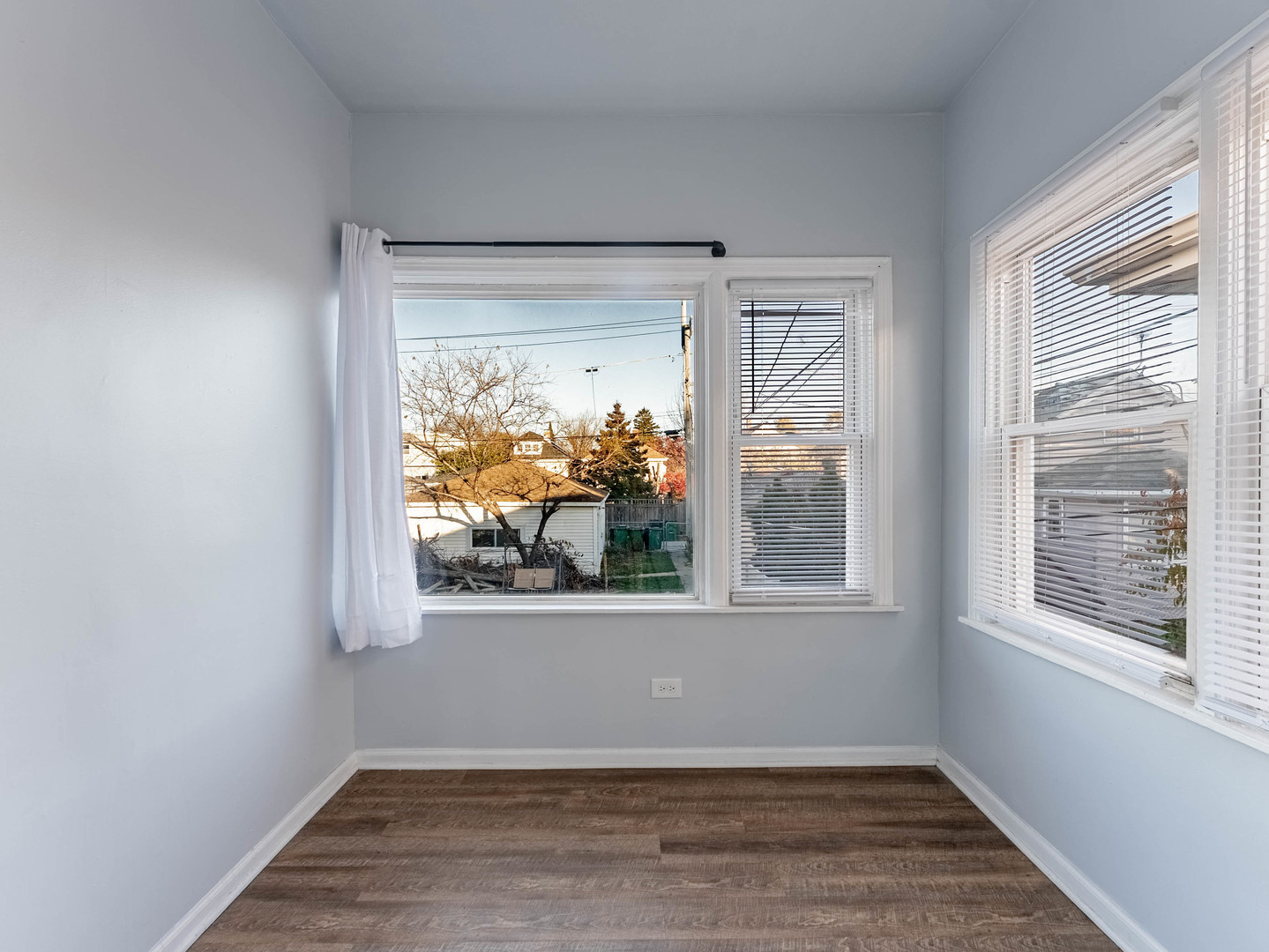 1521 Grove Avenue, Unit 1 Berwyn, IL 60402 - Photo 11 of 27 an empty room with wooden floor and windows