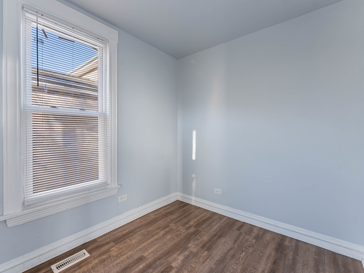 1521 Grove Avenue, Unit 1 Berwyn, IL 60402 - Photo 14 of 27 a view of an empty room with wooden floor and a window