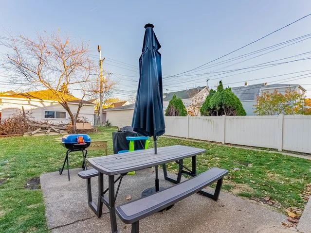 a view of a backyard with sitting area
