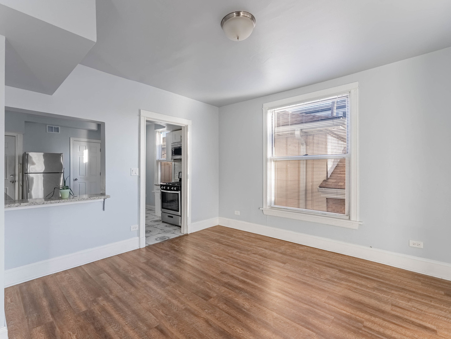 1521 Grove Avenue, Unit 1 Berwyn, IL 60402 - Photo 5 of 27 a view of empty room with wooden floor and fan
