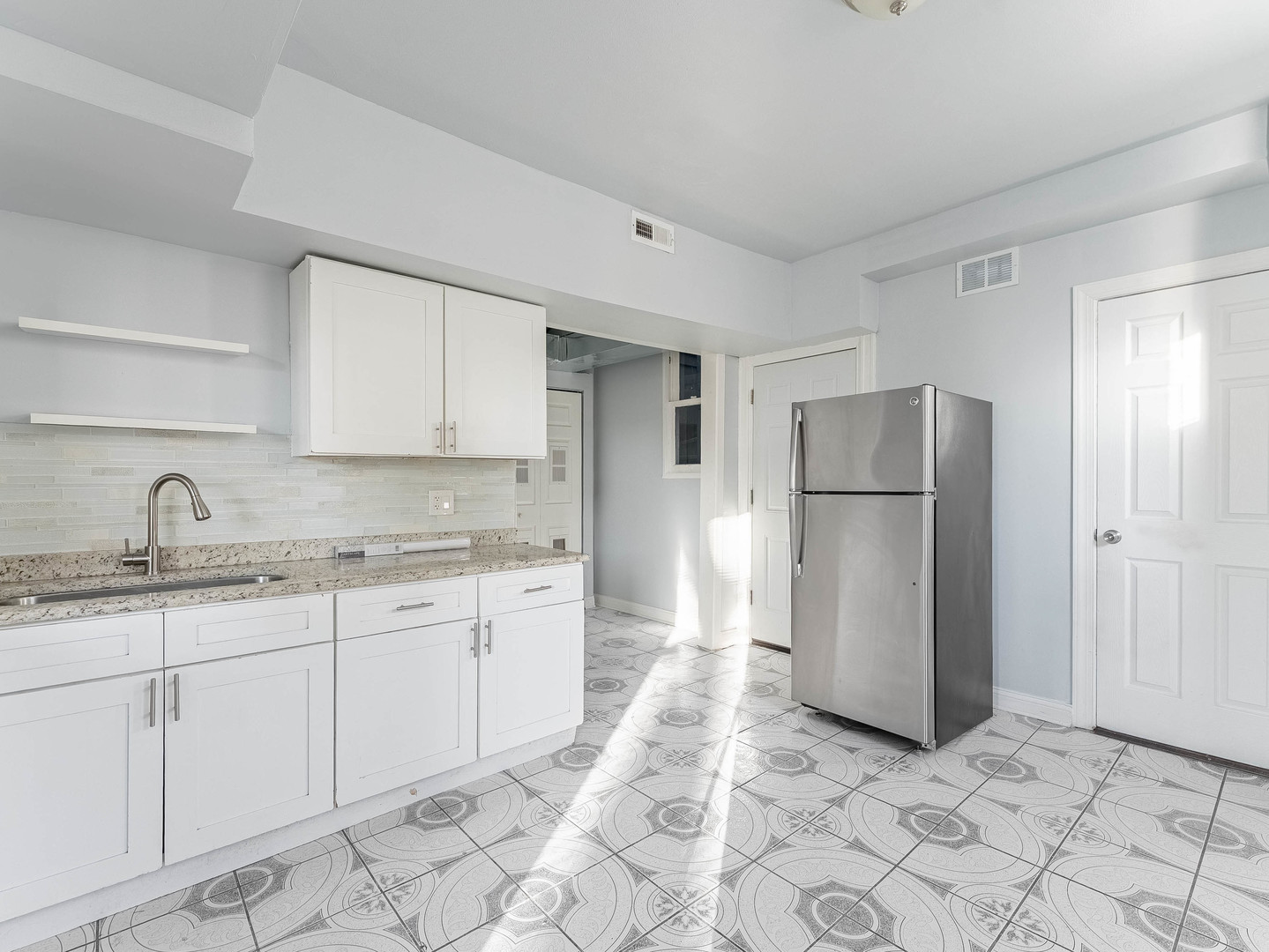 1521 Grove Avenue, Unit 1 Berwyn, IL 60402 - Photo 6 of 27 a kitchen with a refrigerator sink and cabinets