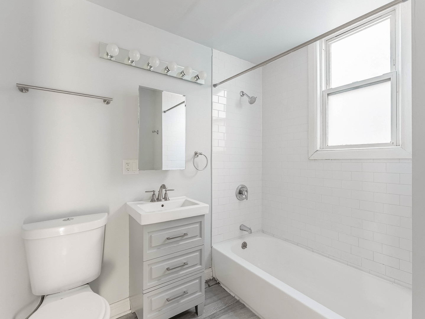1521 Grove Avenue, Unit 1 Berwyn, IL 60402 - Photo 9 of 27 a bathroom with a sink toilet vanity and shower