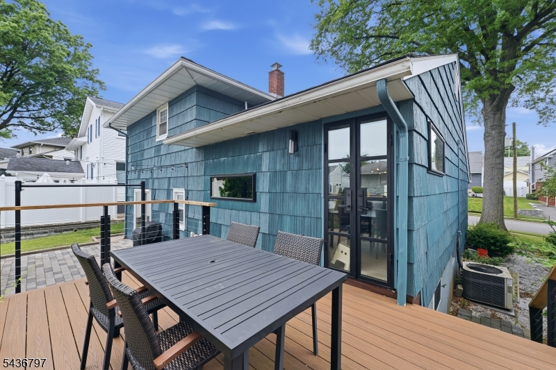 17 Arthur Drive Rutherford, NJ 07070 - Photo 40 of 45 a view of a roof deck with table and chairs floor to ceiling window with wooden floor