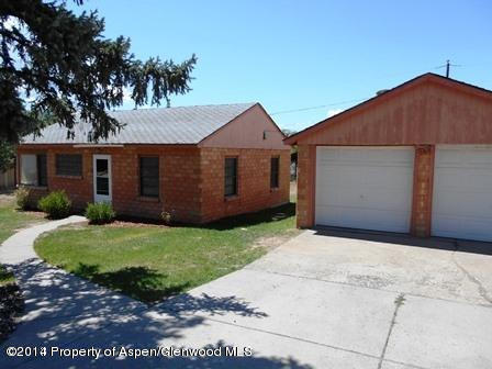 621 Jarrad Avenue Rifle, CO 81650 - Photo 1 of 9 a front view of a house with a yard and garage