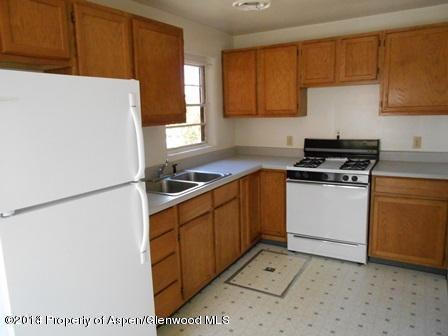 621 Jarrad Avenue Rifle, CO 81650 - Photo 5 of 9 a kitchen with a cabinets and white appliances