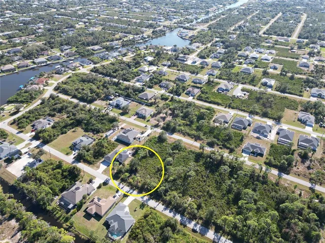 an aerial view of a residential houses with city view