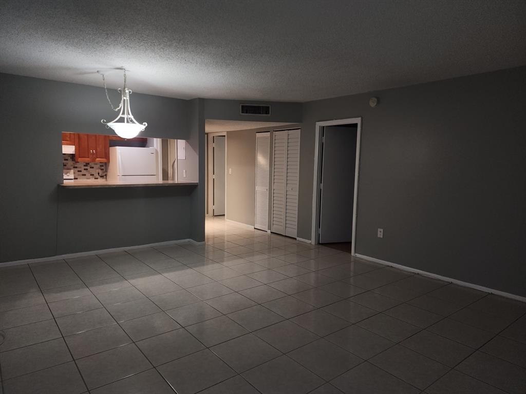 4174 Inverrary Drive, Unit 811 Lauderhill, FL 33319 - Photo 4 of 10 wooden floor in an empty room with a window