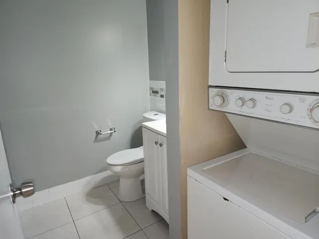 a bathroom with a toilet and a washing machine