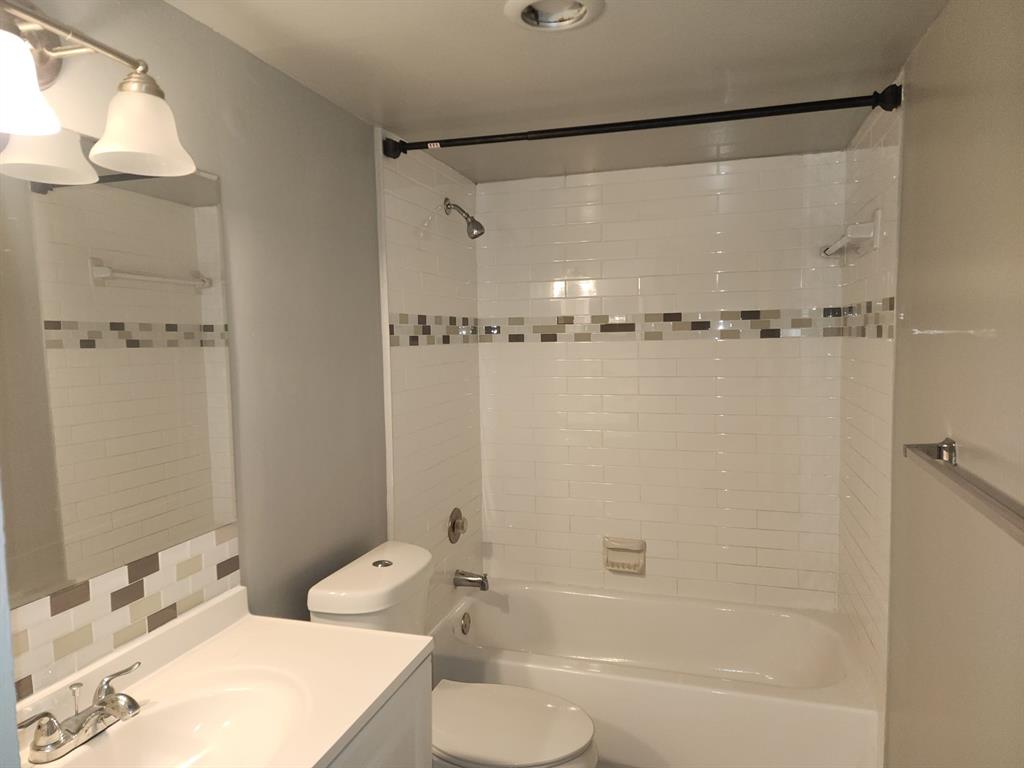 4174 Inverrary Drive, Unit 811 Lauderhill, FL 33319 - Photo 8 of 10 a bathroom with a sink toilet tub and shower