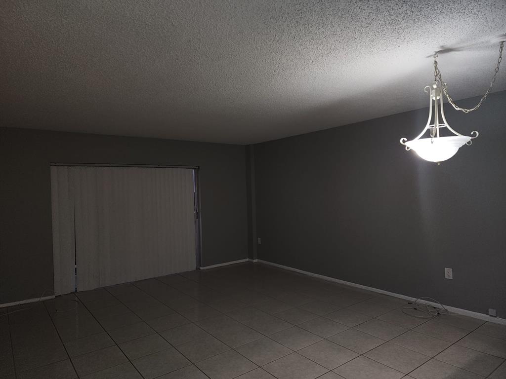 4174 Inverrary Drive, Unit 811 Lauderhill, FL 33319 - Photo 10 of 10 wooden floor in an empty room with a window