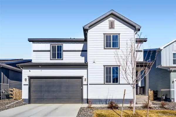 a front view of a house with garage