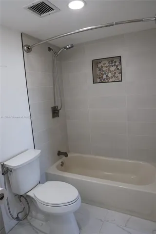 a bathroom with a toilet and a bath tub