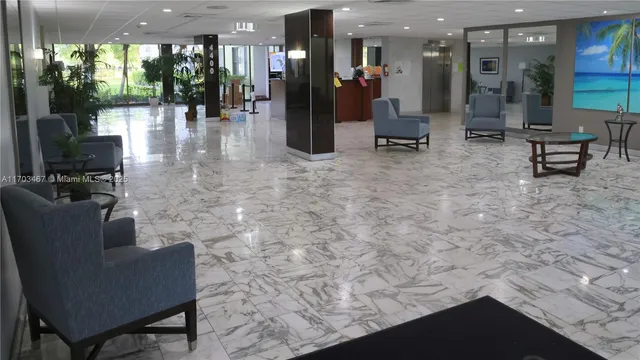 a lobby with furniture and a table