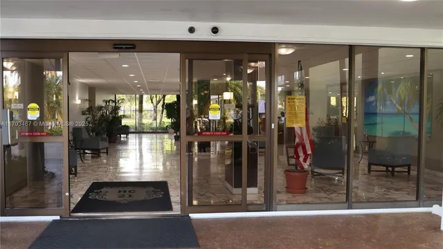 a bathroom with a glass shower door and a glass door