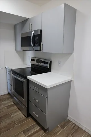 a kitchen with a stove and a microwave