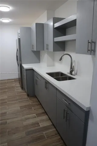 a kitchen with stainless steel appliances a sink and cabinets