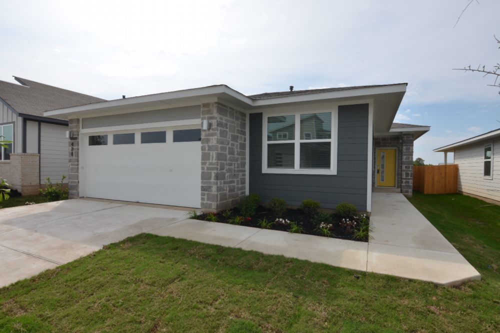 428 Agave Azul Way Leander, TX 78641 - Photo 1 of 24 A modern facade showcases a mix of stone veneer, clean siding, and a neat concrete driveway.