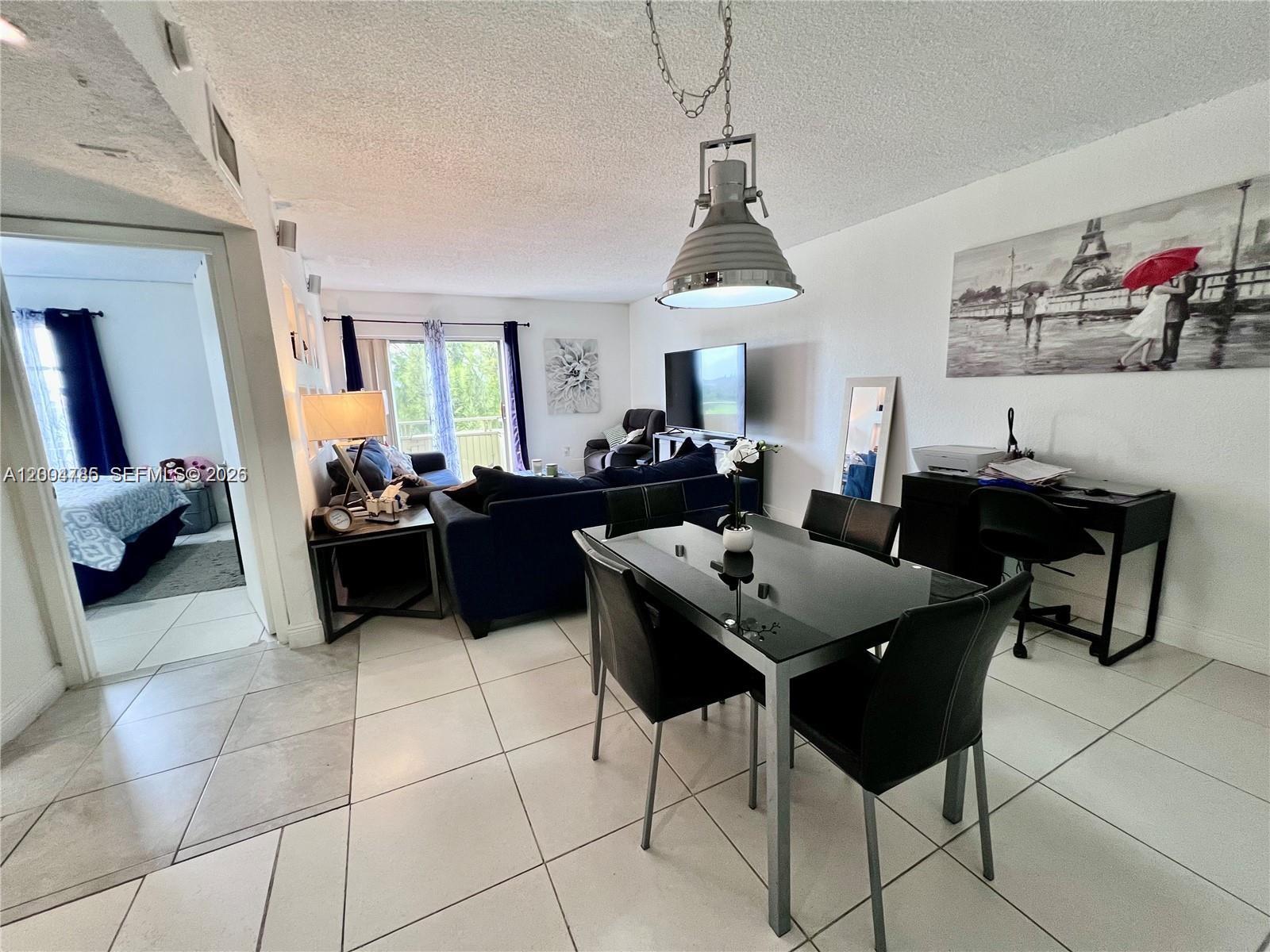 17530 Northwest 68th Avenue, Unit C4008 Hialeah, FL 33015 - Photo 14 of 26 a view of a dining room with furniture