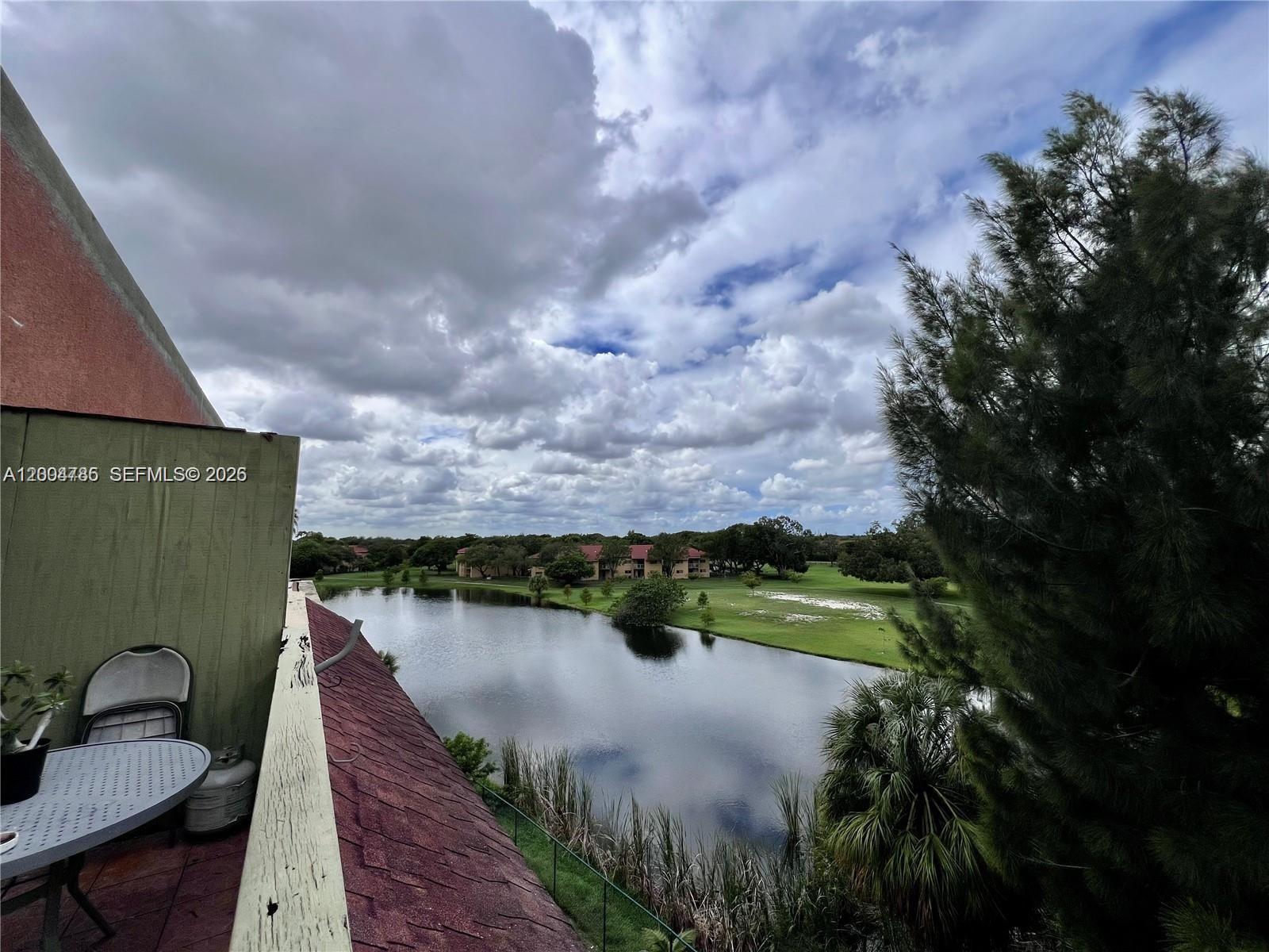 17530 Northwest 68th Avenue, Unit C4008 Hialeah, FL 33015 - Photo 20 of 26 a view of a lake in front of house